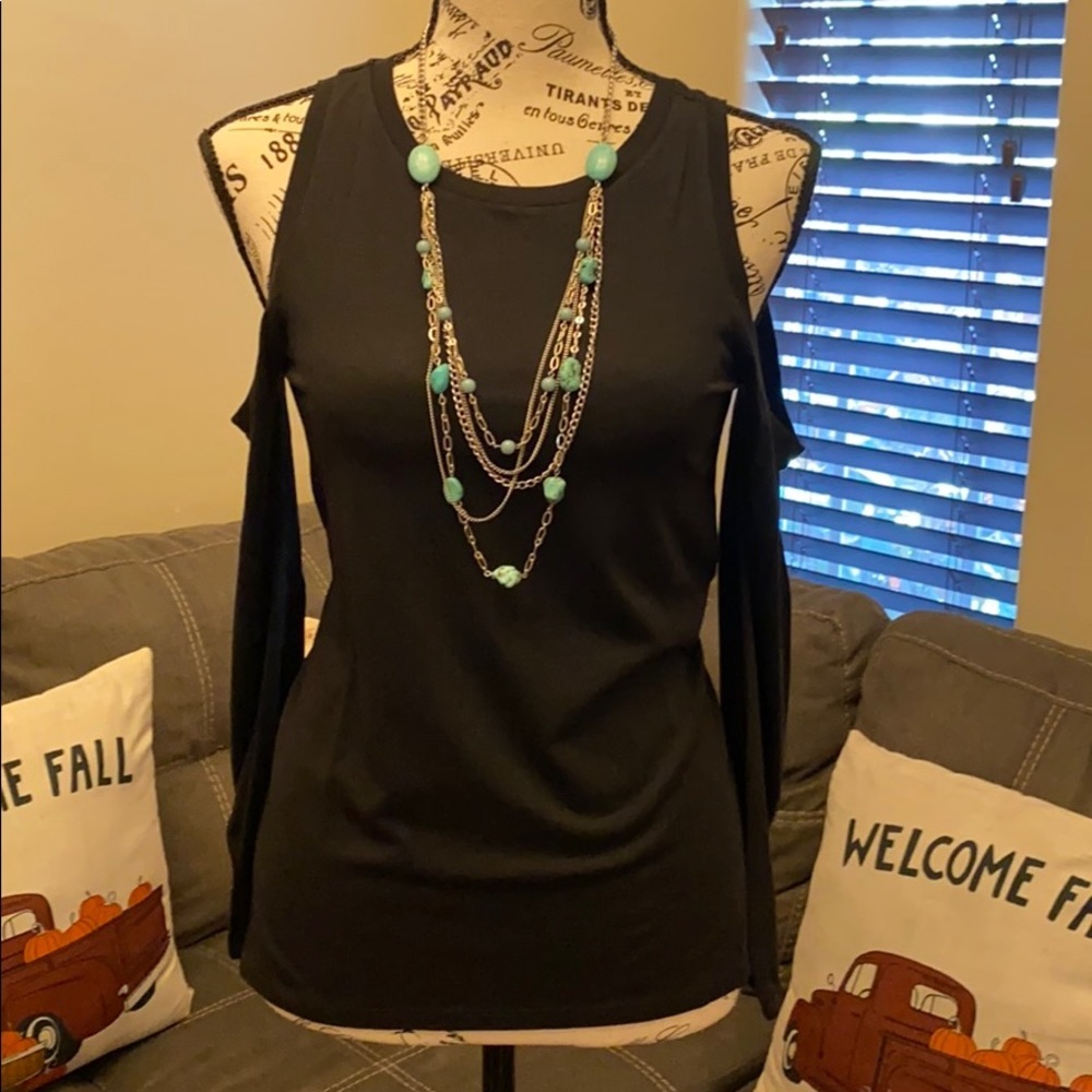 This an a long sleeve cold shoulder blouse in XXSP